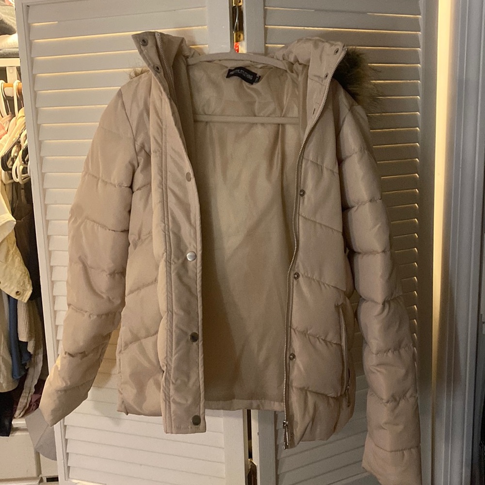 Beige puffer jacket by PrettyLittleThing with fur hood.